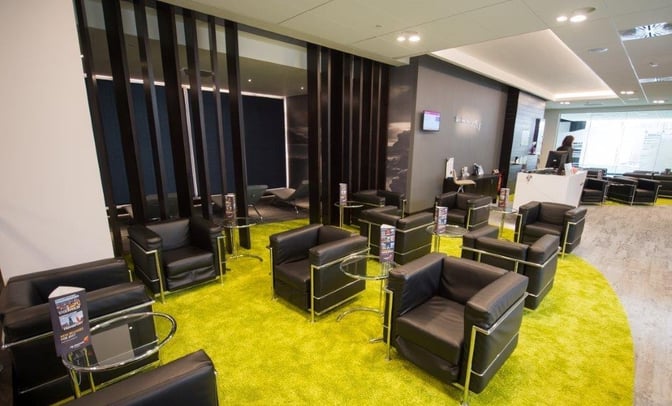 Seating area in Boru Lounge at Shannon International Airport features armchairs and small tables, providing a comfortable waiting space for travelers.