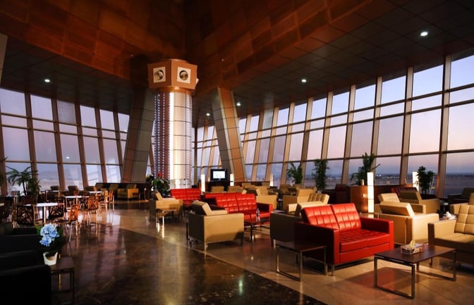 The Pearl Lounge at Sharm el-Sheikh International Airport features spacious seating with views of the runway through large windows.
