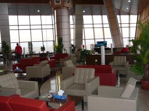 Seating area in the Pearl Lounge at Sharm el-Sheikh International Airport features armchairs and tables, providing a comfortable waiting space.