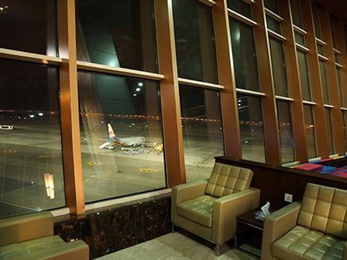 Seating at the Pearl Lounge in Sharm el-Sheikh International Airport offers views of the runway through large windows.