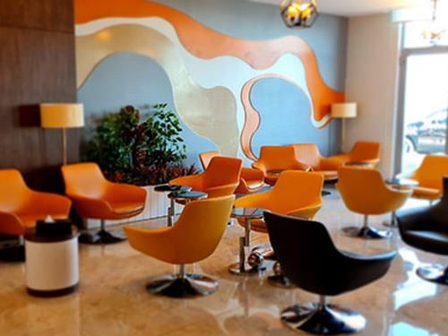 The seating area in Pearl Lounge at Sharm el-Sheikh International Airport features swivel chairs and small tables for passenger comfort.