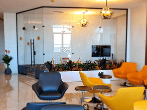 The seating area in Pearl Lounge at Sharm el-Sheikh International Airport features various chairs and tables for passenger relaxation.