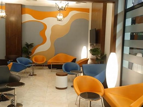 Seating area in Pearl Lounge at Sharm el-Sheikh International Airport features various chairs and small tables for passenger relaxation.