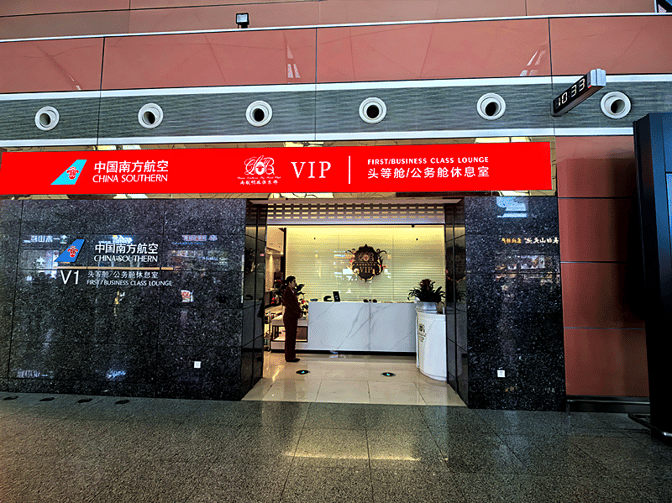 The entrance to China Southern's First/Business Class Lounge at Shenyang Taoxian International Airport features a reception desk and signage.