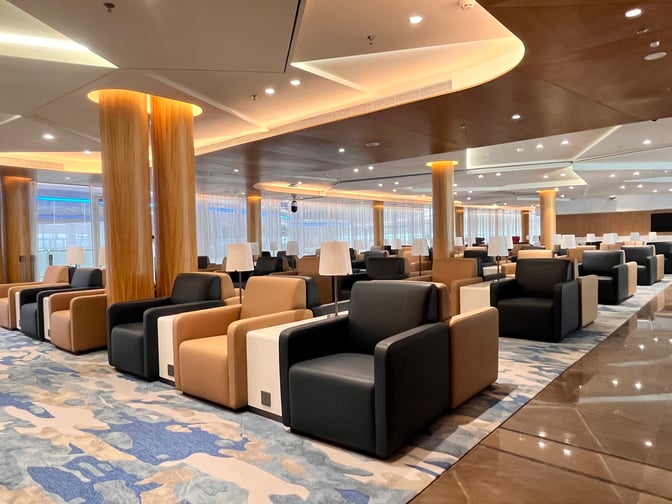 The Shenzhen Airport Domestic VIP Lounge 3 features spacious seating with individual armchairs and tables, providing a comfortable waiting area.