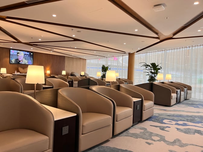 The Shenzhen Airport Domestic VIP Lounge 3 features individual seating with side tables and power outlets, offering a comfortable waiting area.