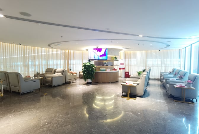 The China Southern Guest Lounge at Shenzhen Bao'an International Airport features comfortable seating and a central refreshment area with beverages.