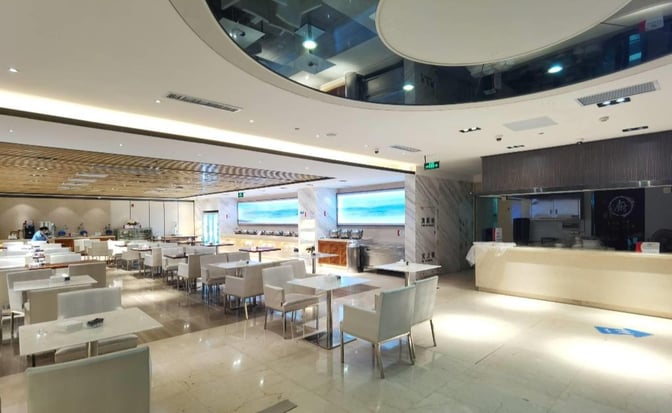 The China Southern No. 3 Lounge at Shenzhen Bao'an International Airport features a spacious dining area with numerous tables and self-serve food stations.