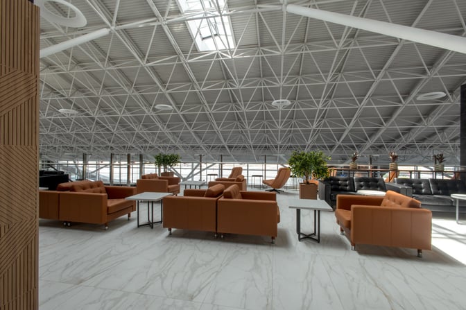 The Sky Hall Lounge at Shymkent International Airport features spacious seating areas with sofas and tables, offering a comfortable waiting environment.