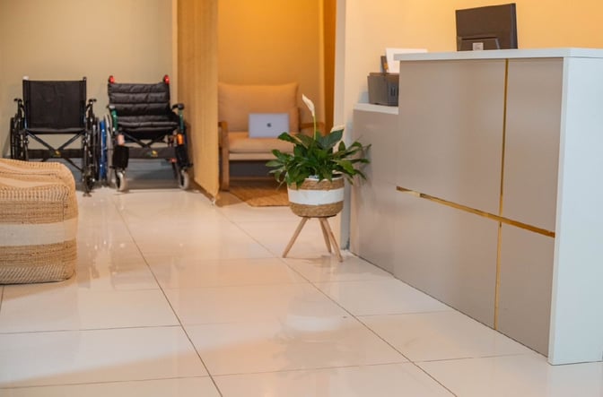 The Softlanding Concierge Lounge at Sir Seretse Khama International Airport features a reception desk, seating area, and wheelchairs for accessibility.