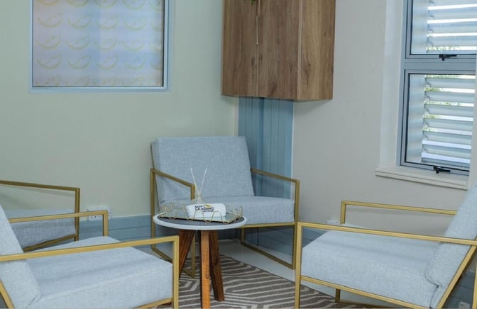 The seating area in the Softlanding Concierge Lounge features comfortable chairs around a small table, ideal for relaxation or conversation.