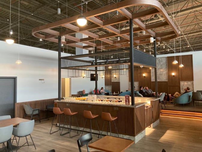 The Primeclass Lounge at Skopje International Airport features a central bar area with counter seating.