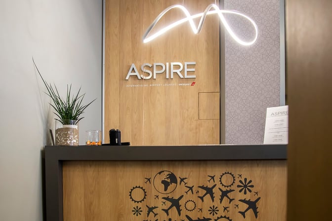 The entrance to the Vitosha Aspire Lounge at Sofia Airport features a reception desk with signage and decorative elements.