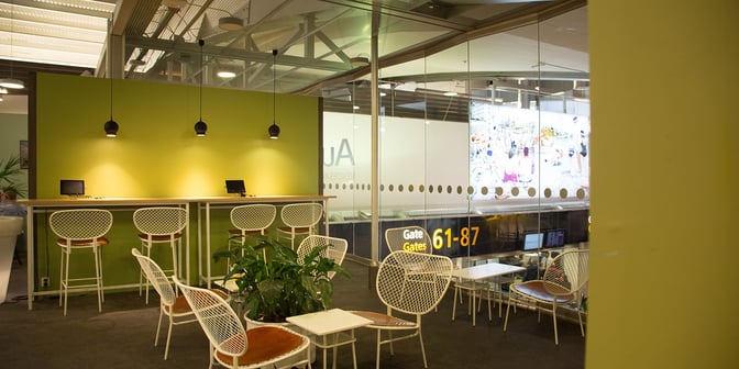 The Pearl Lounge at Stockholm Arlanda Airport features a seating area with tables and chairs near gates 61-87.