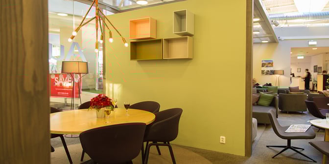 The Pearl Lounge at Stockholm Arlanda Airport features a seating area with a round table and chairs for dining or relaxation.