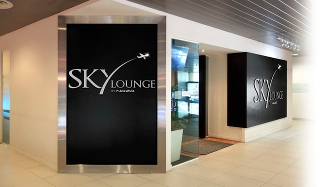 The entrance to the Sky Lounge at Sultan Abdul Aziz Shah Airport features prominent signage and a glass doorway leading inside.