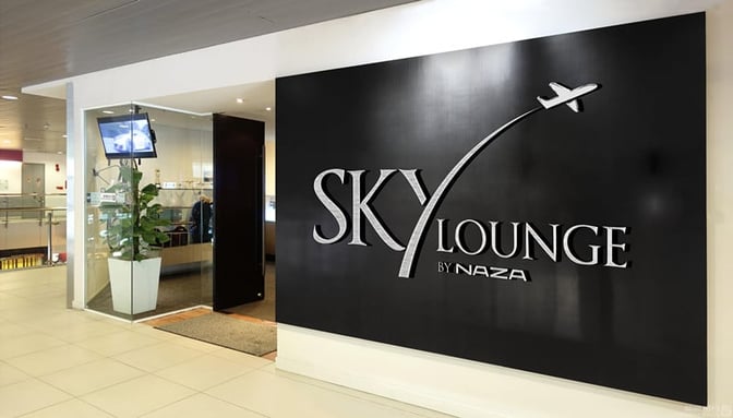 The entrance to the Sky Lounge at Sultan Abdul Aziz Shah Airport features a prominent sign and a glass-walled entryway.