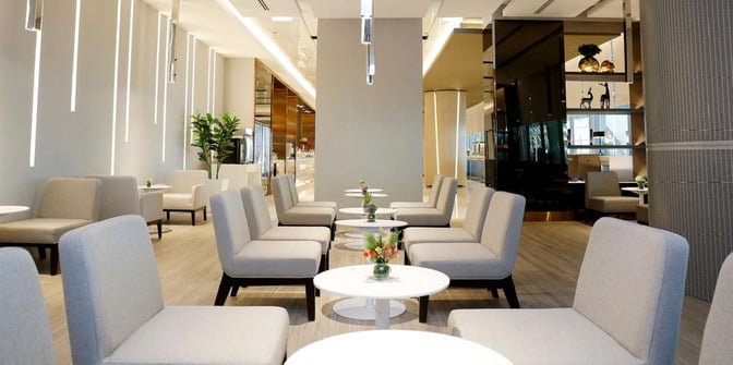 The seating area in the Miracle First Class Lounge at Suvarnabhumi Airport Concourse F features arranged chairs and tables for passenger relaxation.