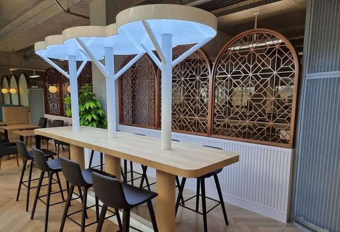 High-top communal tables with barstool seating are available in the Miracle Lounge at Suvarnabhumi Airport, offering a space for socializing.