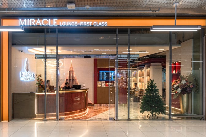 The entrance to the Miracle First Class Lounge at Suvarnabhumi Airport features a reception desk and visible seating area inside.