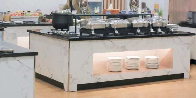 The buffet area at Concordia Lounge, Syamsudin Noor Airport, features self-serve hot dishes and a selection of desserts.