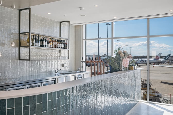 The bar at Plaza Premium Lounge, Sydney Airport, offers a selection of wines and spirits with views of the tarmac.
