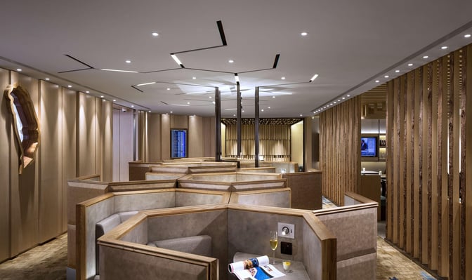 Booth seating in the Plaza Premium Lounge at Taiwan Taoyuan International Airport offers semi-private spaces with individual tables and power outlets.