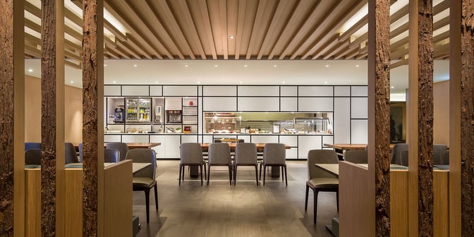 The Plaza Premium Lounge at Taiwan Taoyuan International Airport features a dining area with buffet-style food stations and ample seating.