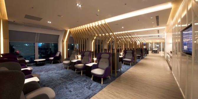 The Oriental Club Lounge at Taiwan Taoyuan International Airport features spacious seating areas with armchairs and tables for passenger relaxation.