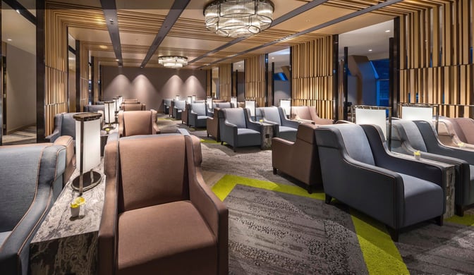 The seating area in Plaza Premium Lounge, Zone A at Taiwan Taoyuan International Airport features comfortable armchairs and side tables for travelers.