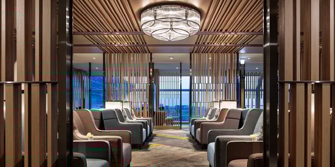 The seating area in Plaza Premium Lounge, Zone A at Taiwan Taoyuan International Airport, features rows of comfortable chairs with privacy dividers.