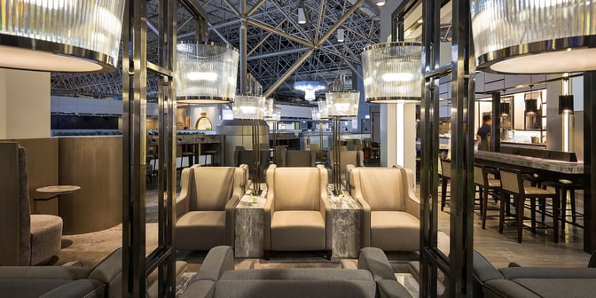 The seating area in Plaza Premium Lounge, Zone A1 at Taiwan Taoyuan International Airport, features comfortable armchairs and adjacent tables.