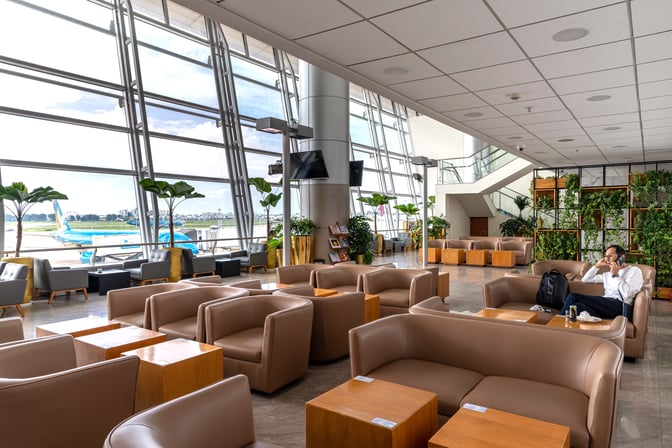 The seating area at Jasmine Halal Lounge in Tan Son Nhat International Airport offers comfortable chairs with views of the runway.