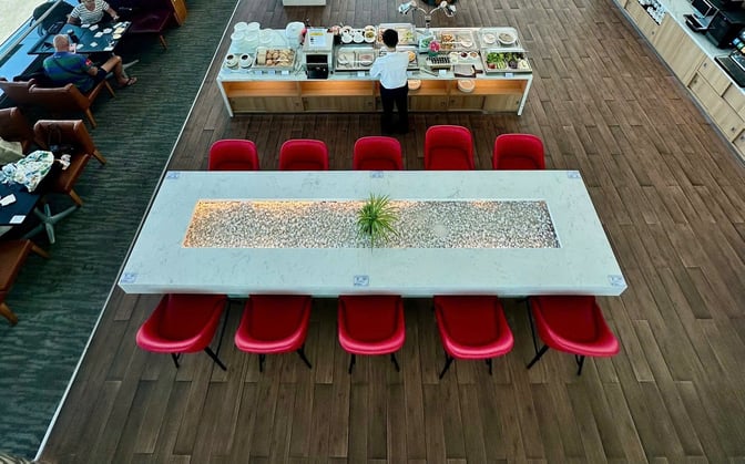 The Rose Business Lounge at Tan Son Nhat International Airport features a buffet area with a variety of self-serve food options.