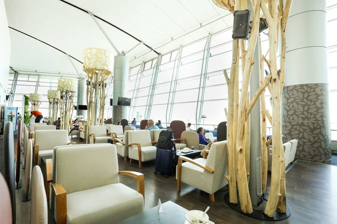 The seating area in the Rose Business Lounge at Tan Son Nhat International Airport offers comfortable chairs with tables and airport views.