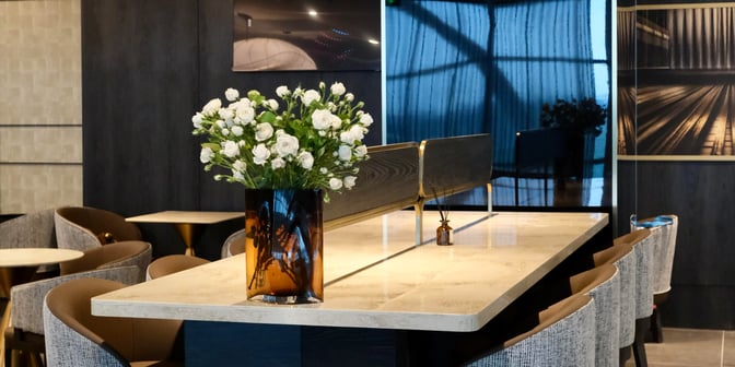 The SENS Business Lounge at Tan Son Nhat International Airport features a seating area with tables and chairs for dining and relaxation.