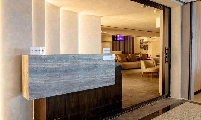 The entrance to the BRT Lounge at Tancredo Neves International Airport features a reception desk and visible seating area inside.