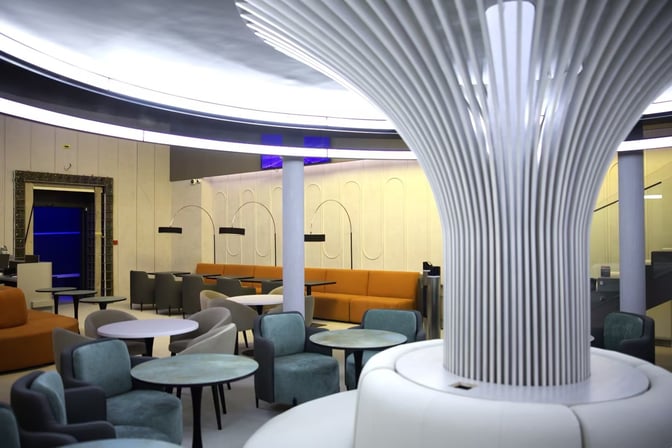 The Anjir Business Lounge at Tashkent International Airport features a seating area with various chairs and tables for travelers.