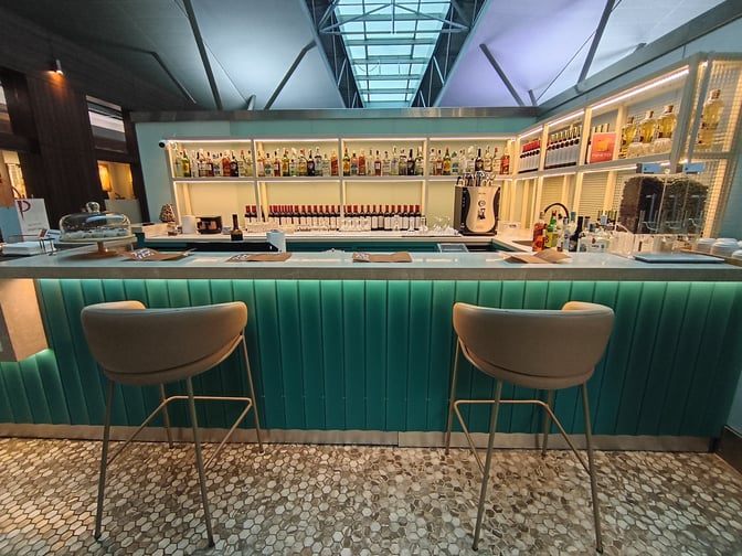 The bar at Primeclass CIP/VIP Lounge in Tbilisi International Airport offers a selection of spirits and wines with counter seating.