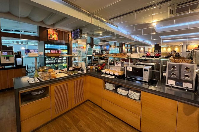 The Primeclass CIP/VIP Lounge at Tbilisi International Airport features a self-serve food area with a variety of snacks and beverages.