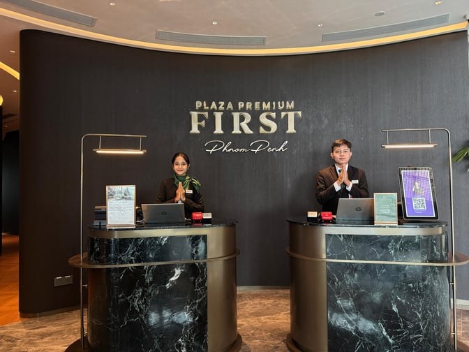 The reception area of Plaza Premium First at Techo International Airport features two service counters with staff ready to assist travelers.