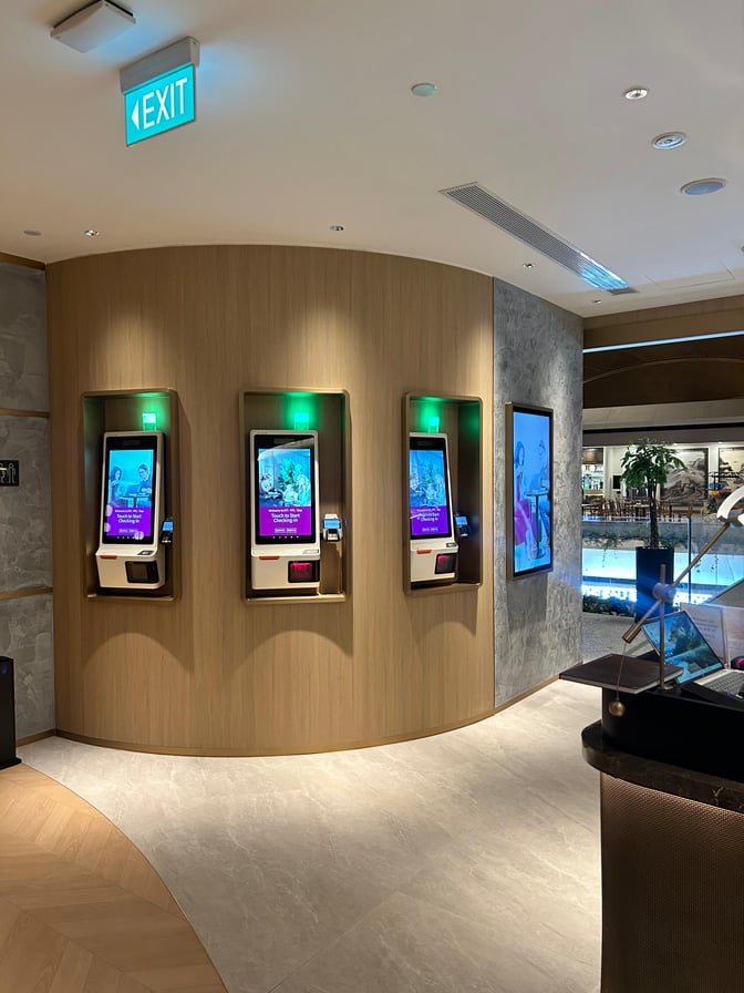 Automated check-in kiosks at Plaza Premium Lounge, Techo International Airport, facilitate quick self-service entry for travelers.