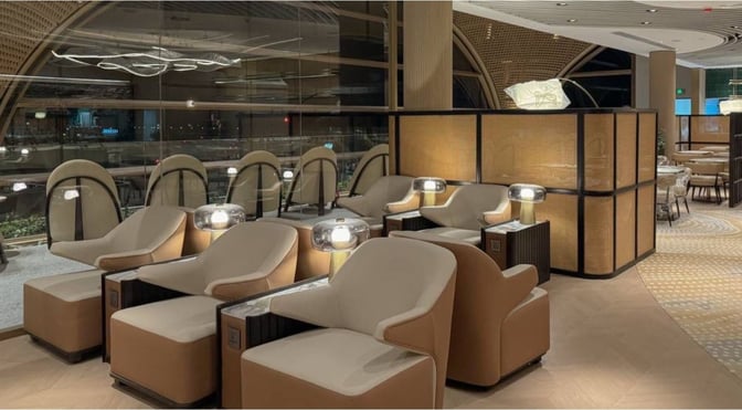 The seating area in the Plaza Premium Lounge at Techo International Airport features comfortable chairs with individual lamps and power outlets.