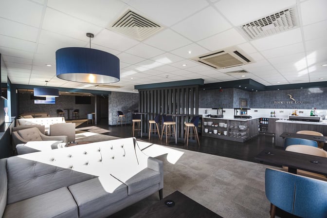 The Rockliffe Lounge at Teesside International Airport features a seating area with sofas and a bar offering beverages and snacks.