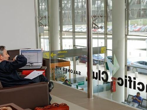 The Salones VIP Pacific Club at Temuco Airport offers seating with views of the terminal and runway through large glass windows.