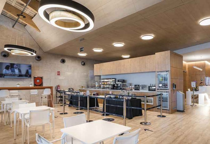 The Sala VIP Nivaria at Tenerife North Airport features a self-serve food area with seating and a television for entertainment.