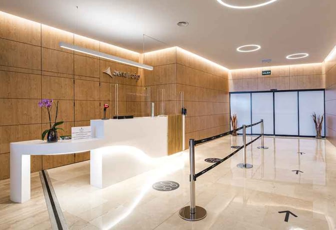 The entrance to Sala VIP Nivaria at Tenerife North Airport features a reception desk and directional signage for guest assistance.