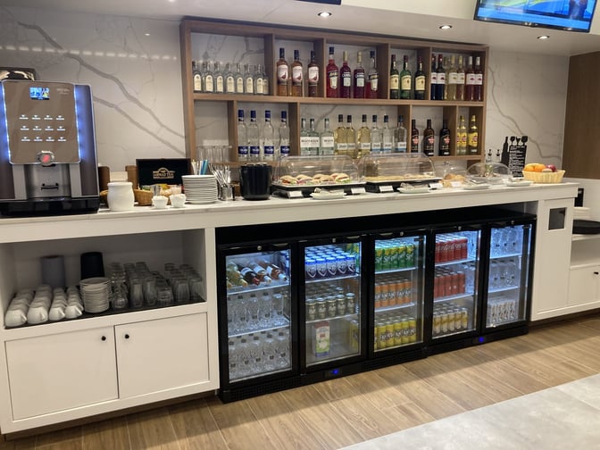 The Lounge Thessaloniki offers a self-serve beverage station with a variety of spirits, soft drinks, and a coffee machine.