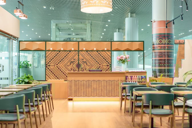 The SH Premium Lounge at Tho Xuan Airport features a reception desk with seating area and decorative wall panels.
