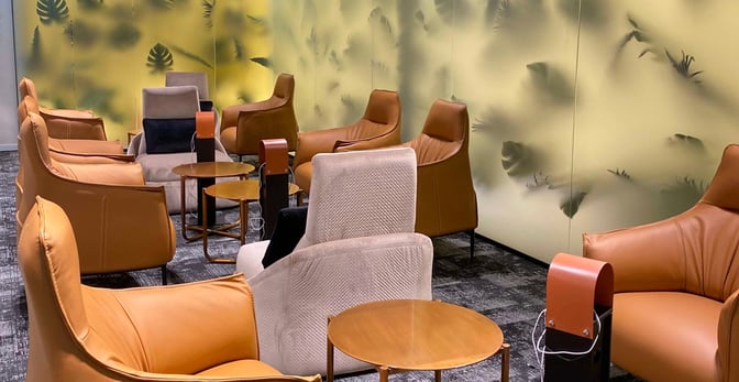 The seating area in Scanderbeg Lounge at Tirana International Airport features comfortable chairs and small tables, ideal for relaxation.
